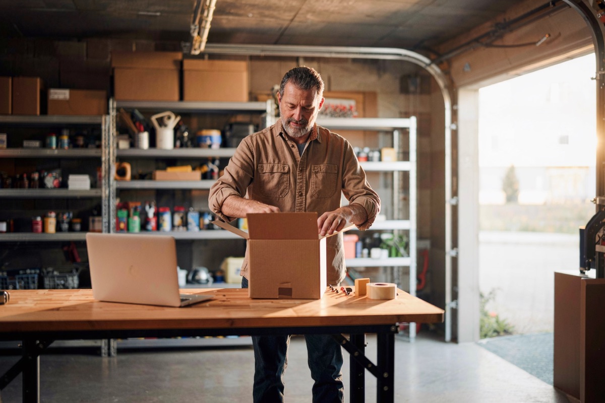 A seller packing orders in his garage workshop